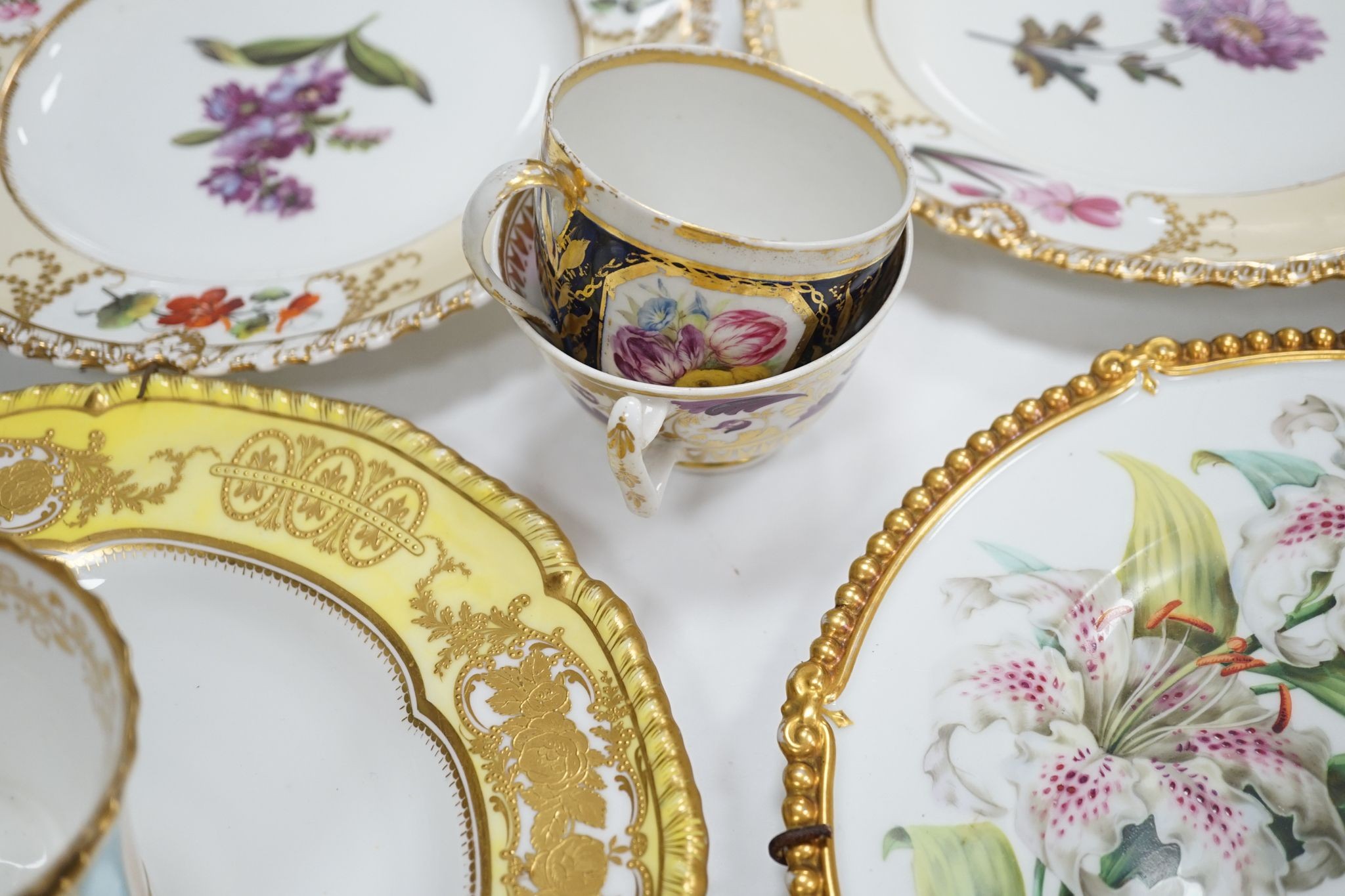 A small collection of Victorian porcelain tea cups and saucers and sundry dessert plates